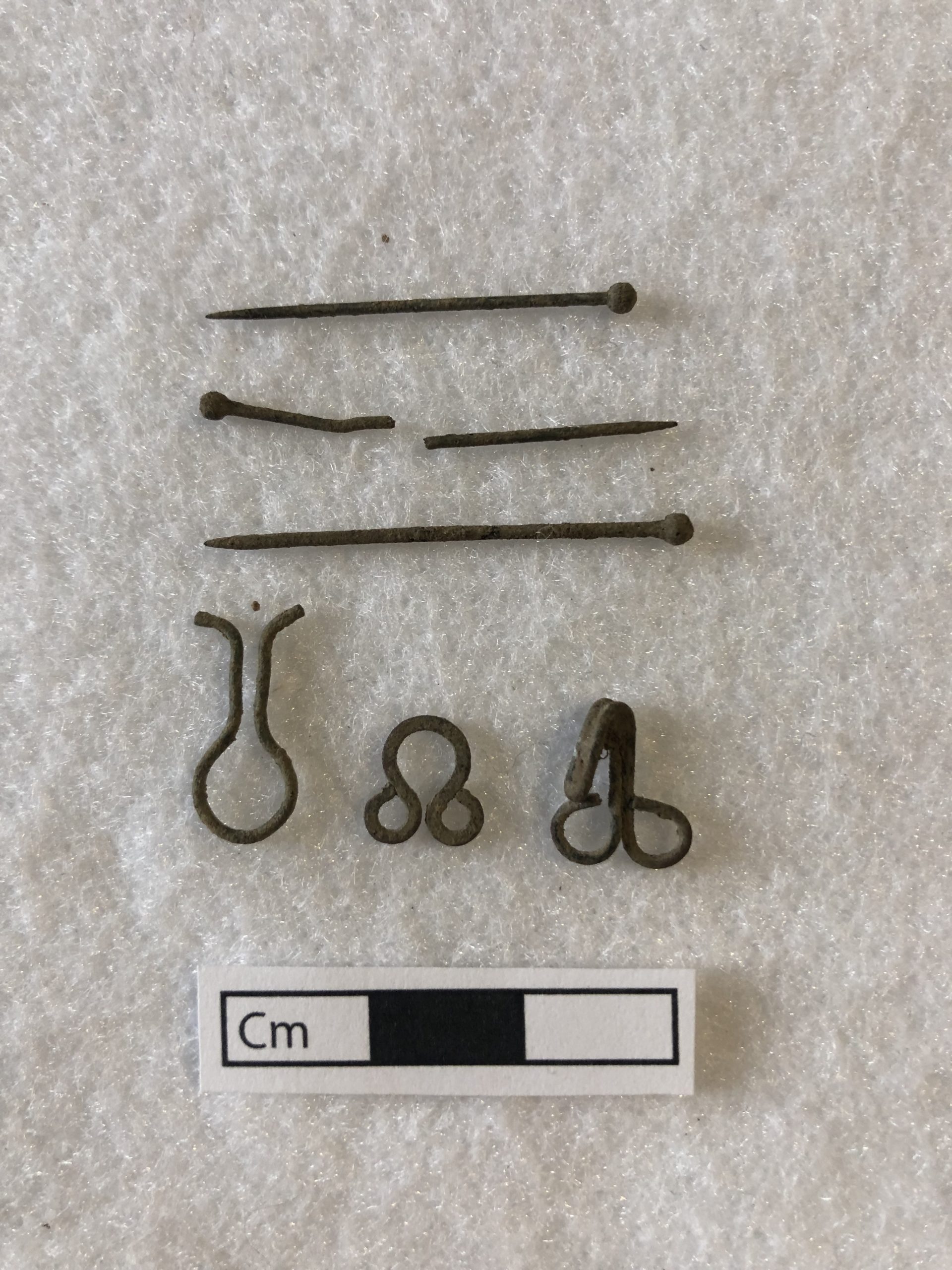 Artifacts discovered during excavation of John Bell House, including pins and clasps.
