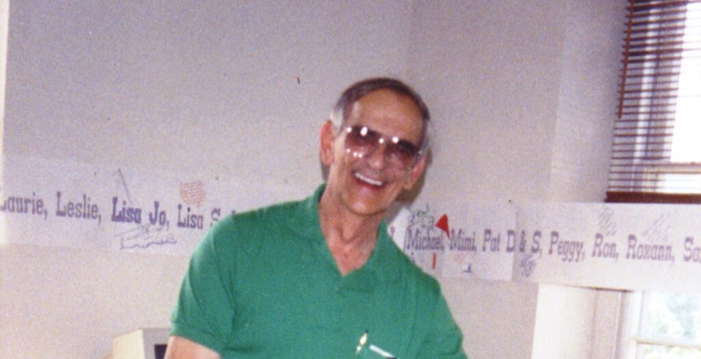 Headshot of Bill Hopkins from shoulders up, smiling while wearing park uniform in office setting.
